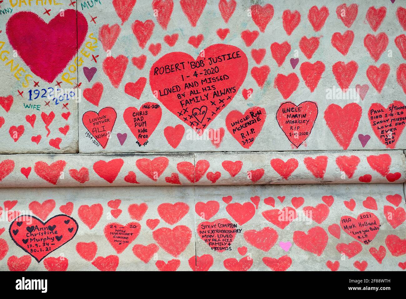 The National Covid Memorial Wall on Southbank, covered in thousands of hand drawn hearts, in memory of all the lives lost  to the COVID-19 pandemic. Stock Photo