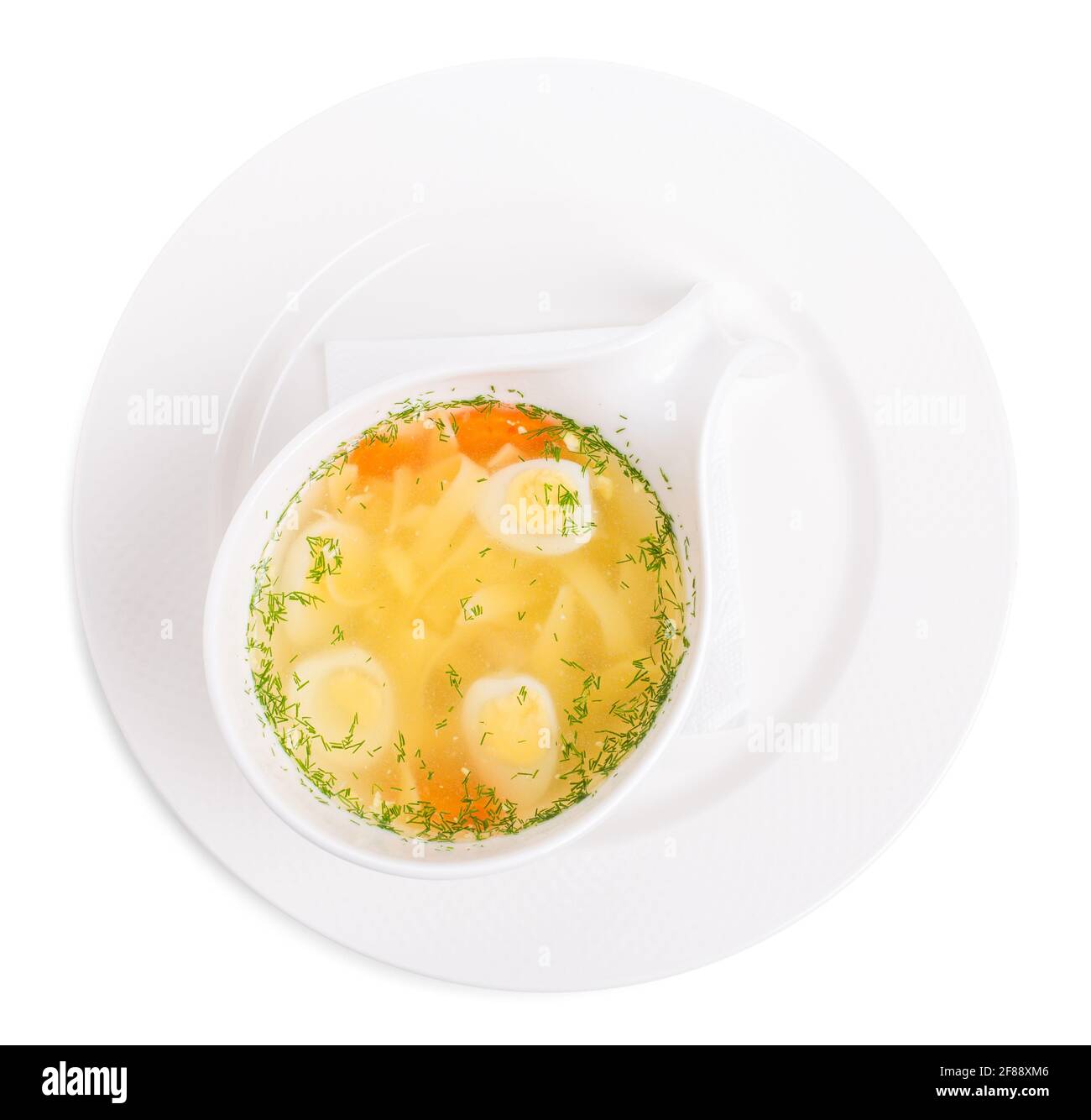 Chicken consomme soup with homemade noodles and quail eggs. Isolated on