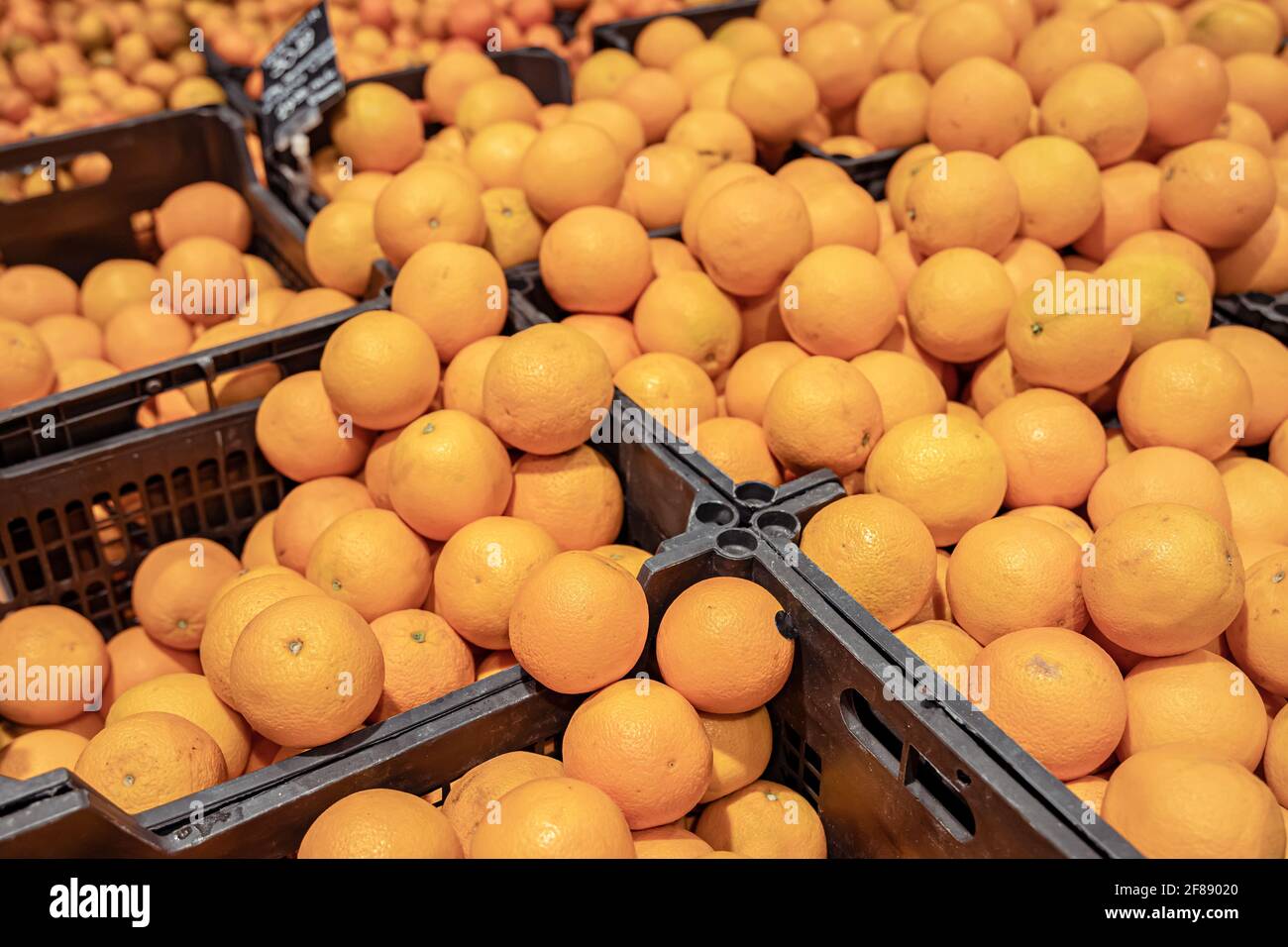 Close up of fresh natural oranges in crates in a grocery store Stock