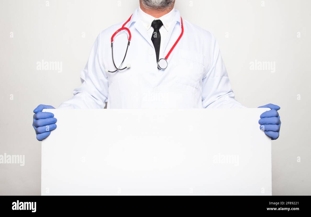 Portrait of a doctor showing blank placard. Stock Photo