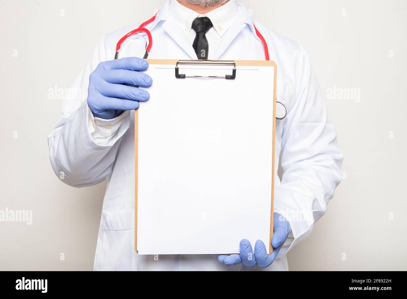 Doctor holds a clipboard with blank space for text Stock Photo