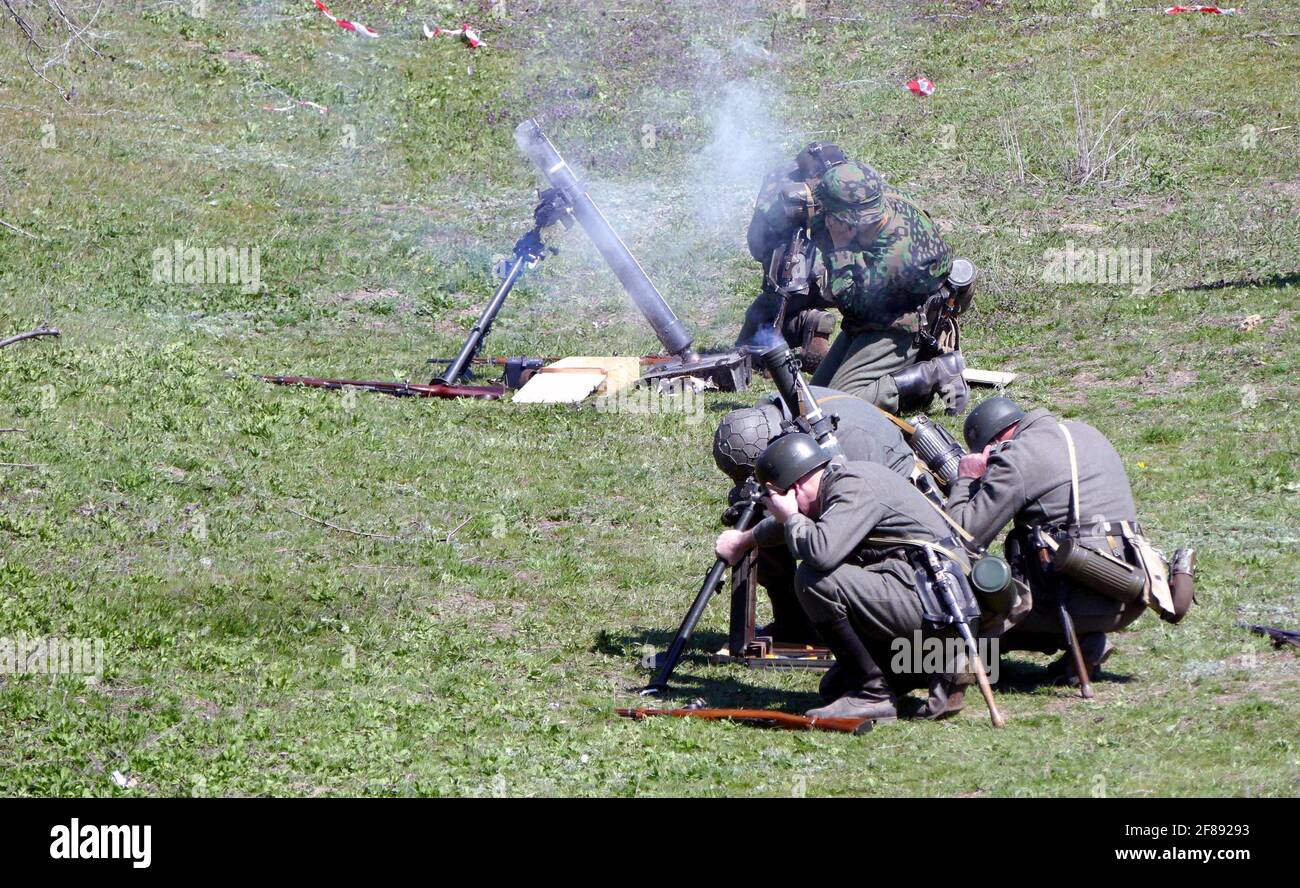 Non Exclusive: ILLINKA, UKRAINE - APRIL 11, 2021 - History enthusiasts in period military uniforms react to the launch of a mortar during the re-enact Stock Photo