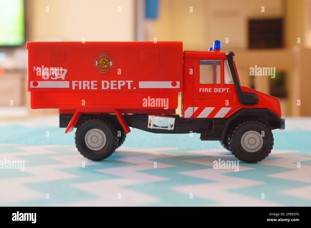 POZNAN, POLAND - Feb 19, 2017: Red Welly toy fire department truck on table in soft focus Stock Photo