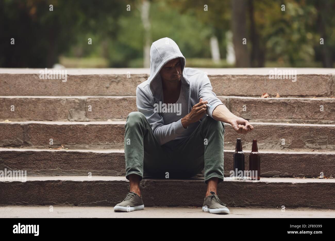 Male junkie making injection outdoors Stock Photo - Alamy