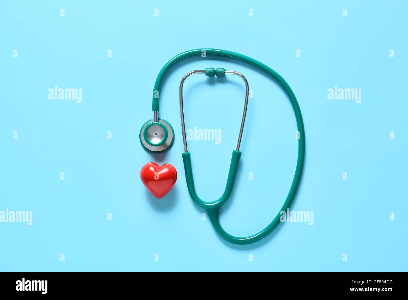Modern stethoscope and heart on color background Stock Photo - Alamy