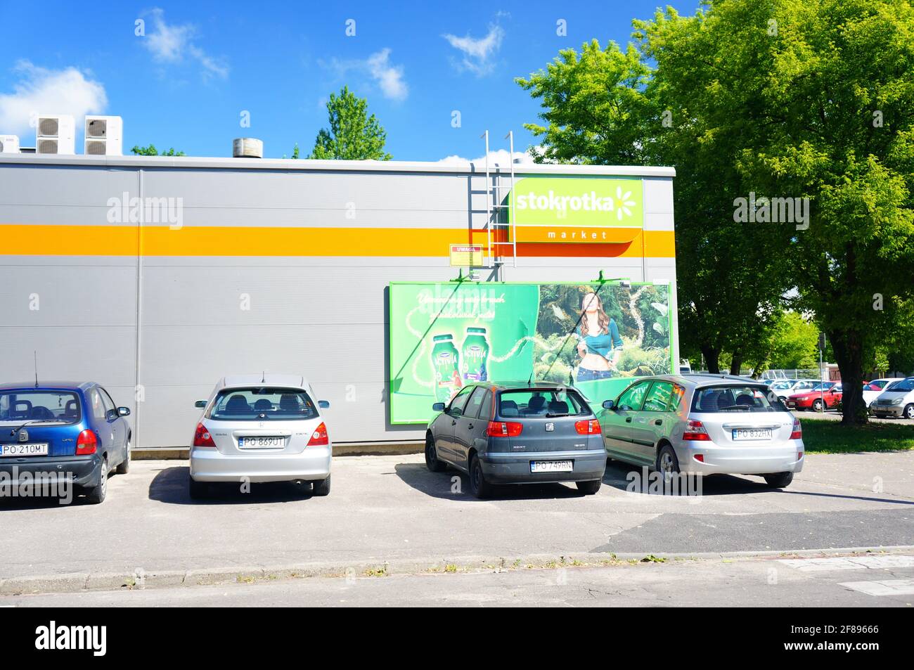 POZNAN, POLAND - May 25, 2014: Parked cars in front of an Stokrotka supermarket Stock Photo