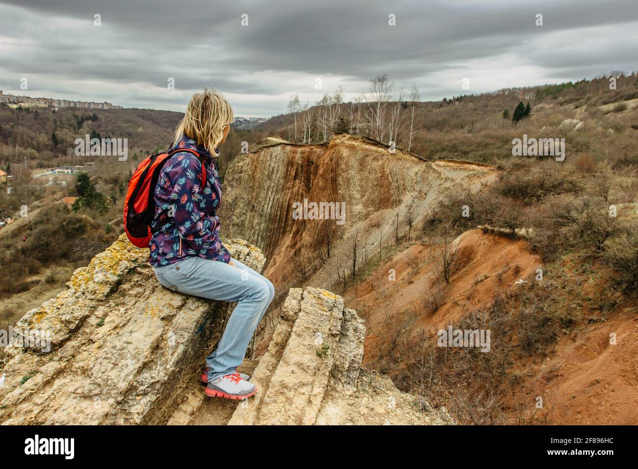 Girl with backpack enjoying view of Prokopske valley nature reserve, Prague,Czech Republic.Attractive landscape with deep valleys, local streams Stock Photo