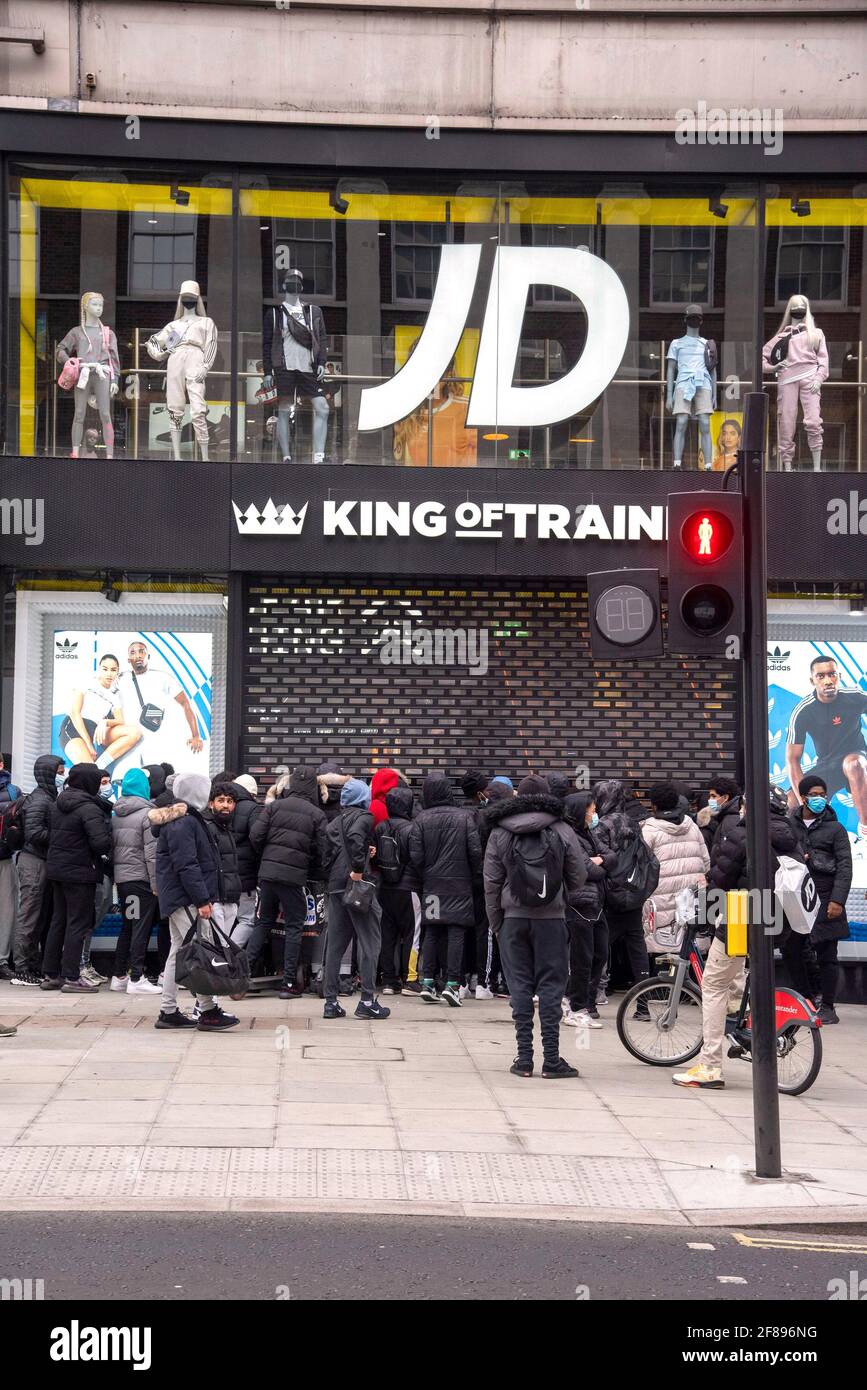 A large group of shoppers wait for the JD Sports store to open in Oxford Street, London as non essential shops reopen after the 4th lockdown. Stock Photo
