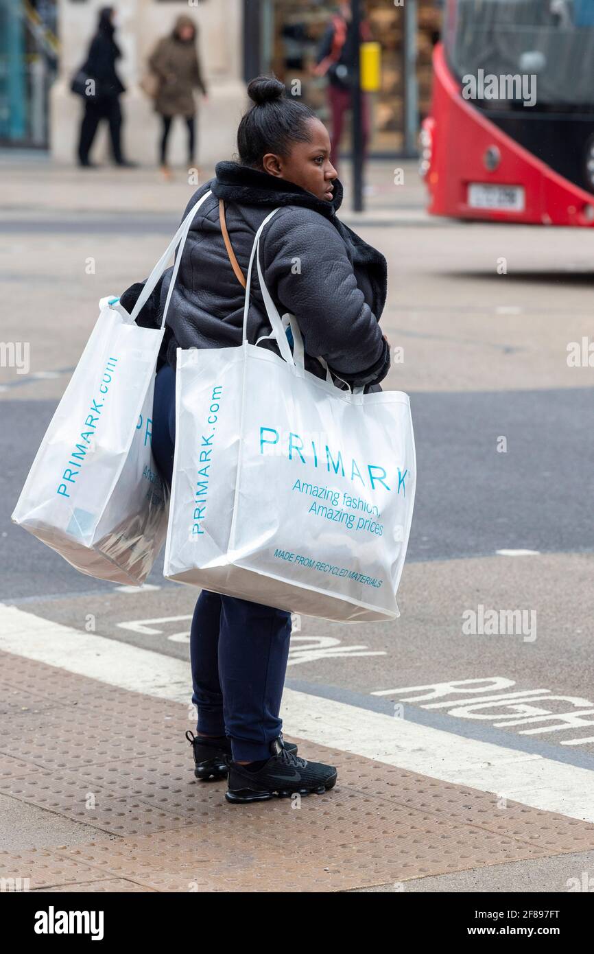 A woman carries Primark shopping bags in London's Oxford Street after non essential shops were allowed to reopen. by Rushen / SOPA Images/Sipa USA Stock Photo - Alamy