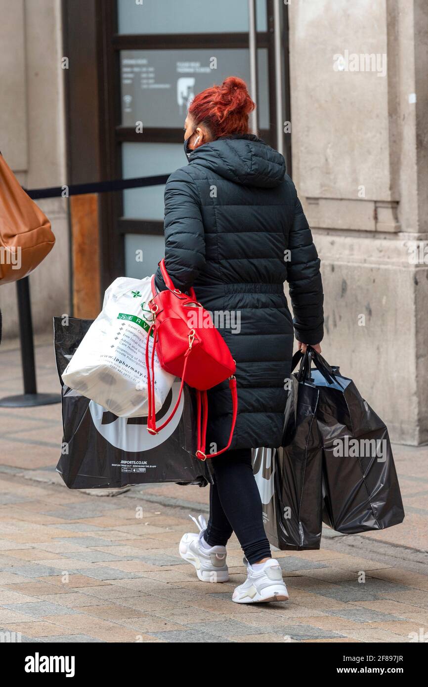 A shopper carries a Louis Vuitton shopping bag on London's Oxford Street  after the shops were allowed to reopen. (Photo by Dave Rushen / SOPA  Images/Sipa USA Stock Photo - Alamy