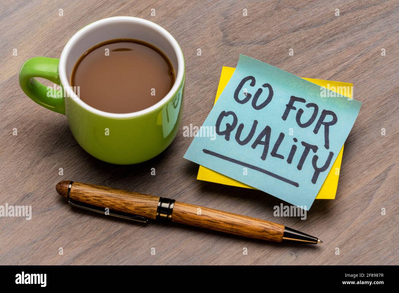 go for quality reminder note with a cup of coffee and pen, business, lifestyle and personal development concept Stock Photo