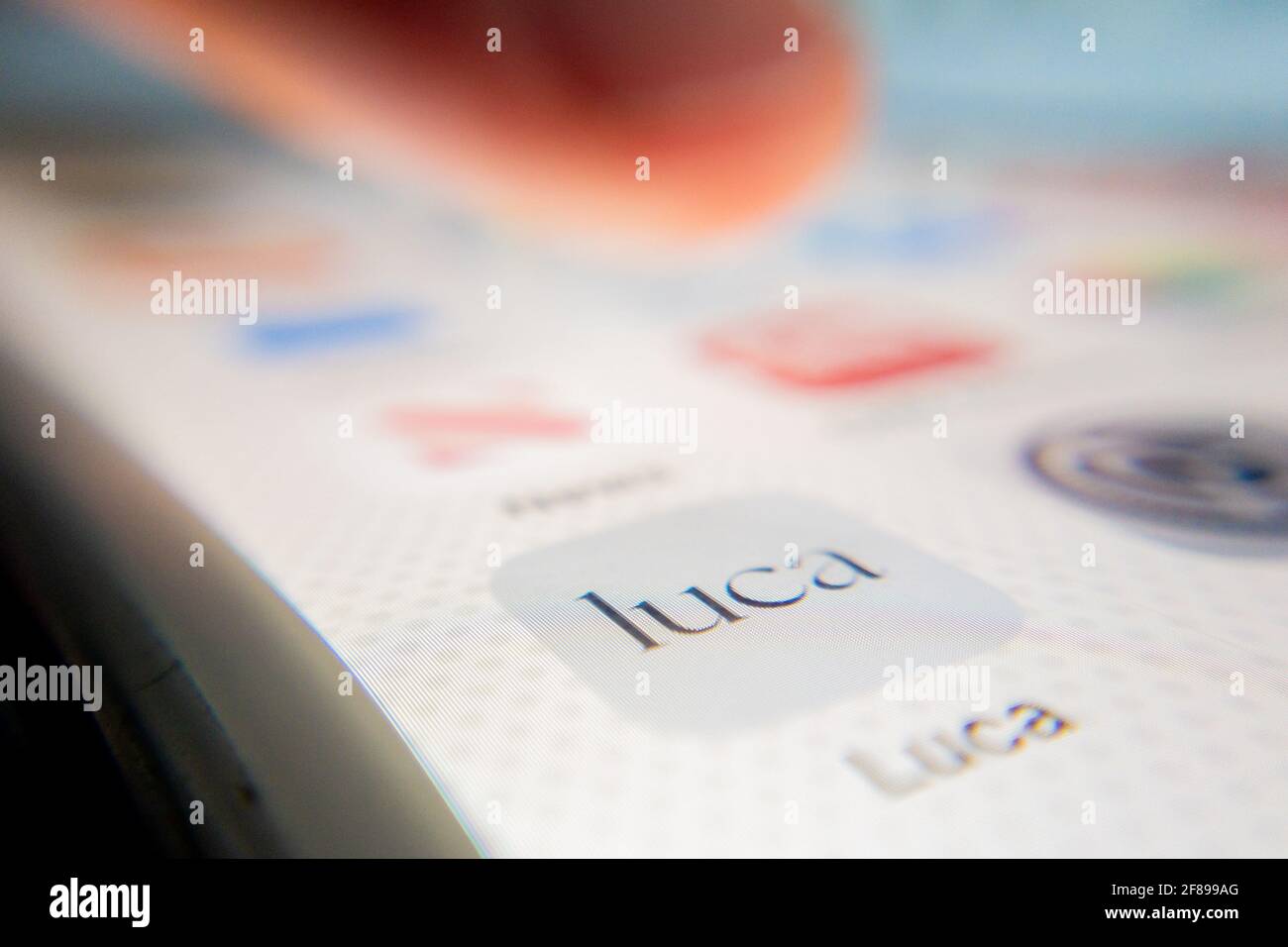Berlin, Germany. 12th Apr, 2021. ILLUSTRATION - A person points to the Luca app icon on a smartphone. The app is used to provide data for a possible contact tracing. (posed scene) Credit: Christoph Soeder/dpa/Alamy Live News Stock Photo