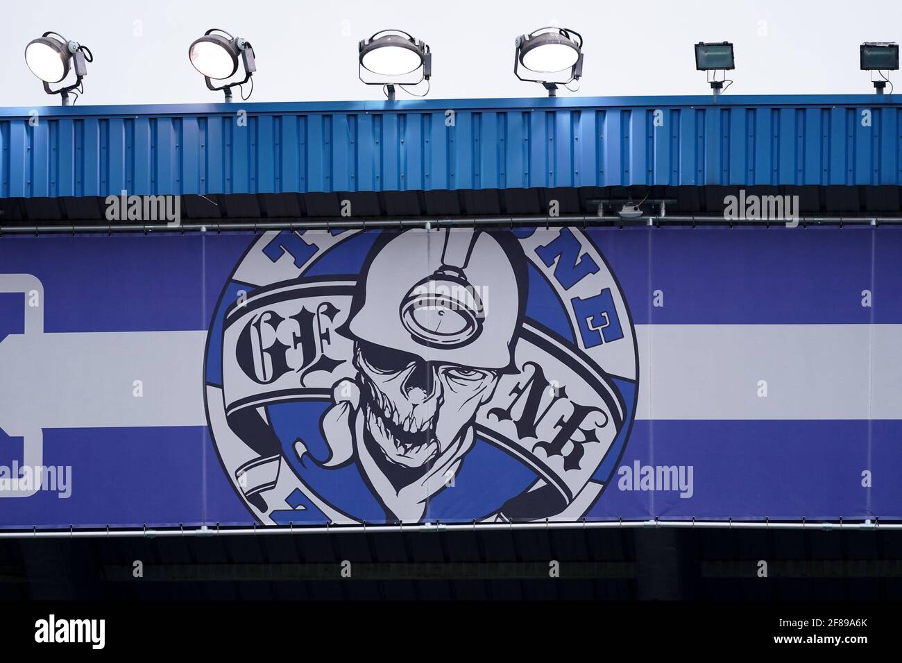 GENK, BELGIUM - APRIL 11: KRC Genk banner of a mineworker attached to the stadiium roof during the Jupiler Pro League match between KRC Genk and Sint- Stock Photo