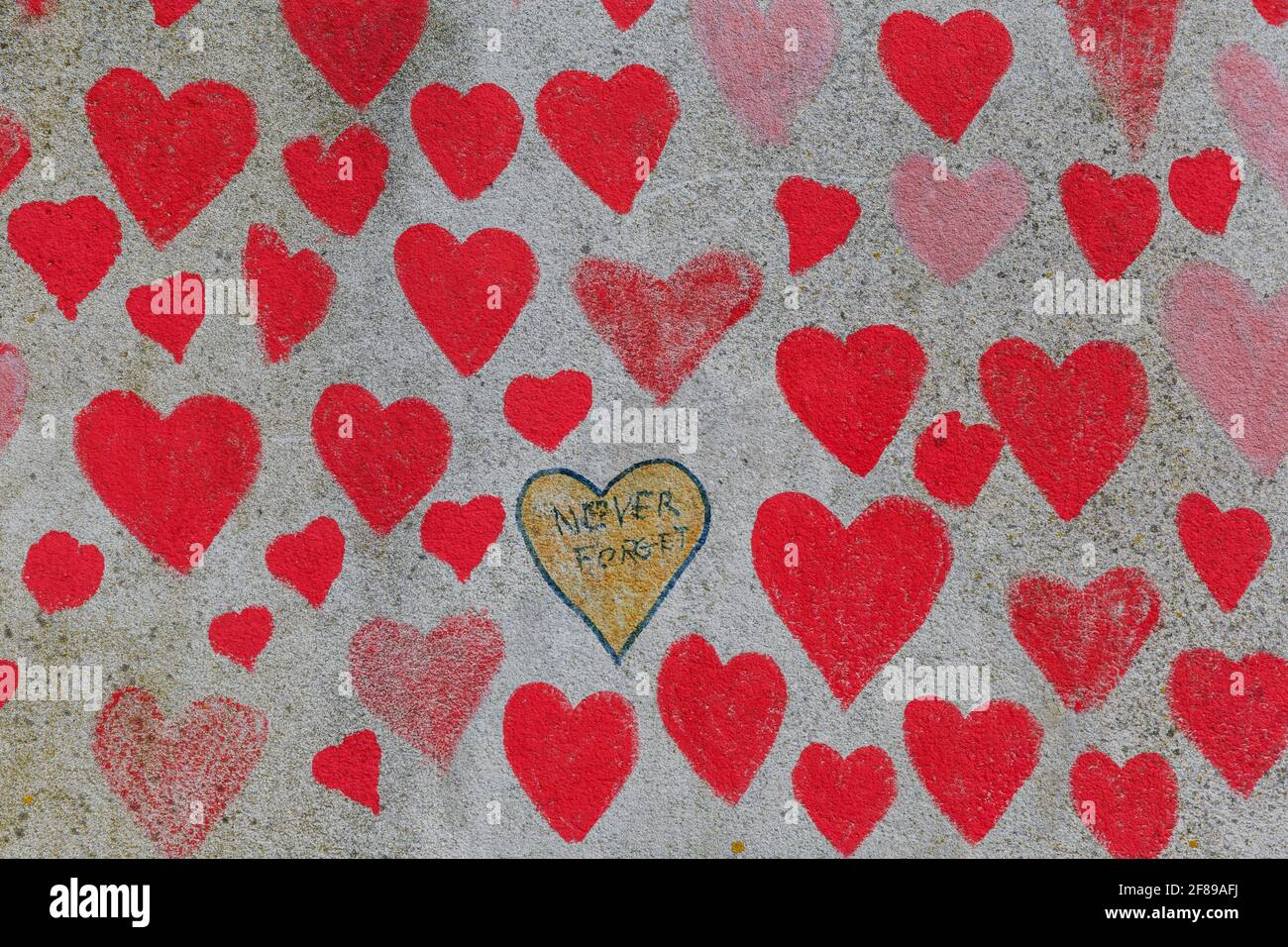 Red hearts painted on the National Covid Memorial Wall as a tribute to the British victims of the Coronavirus pandemic Stock Photo