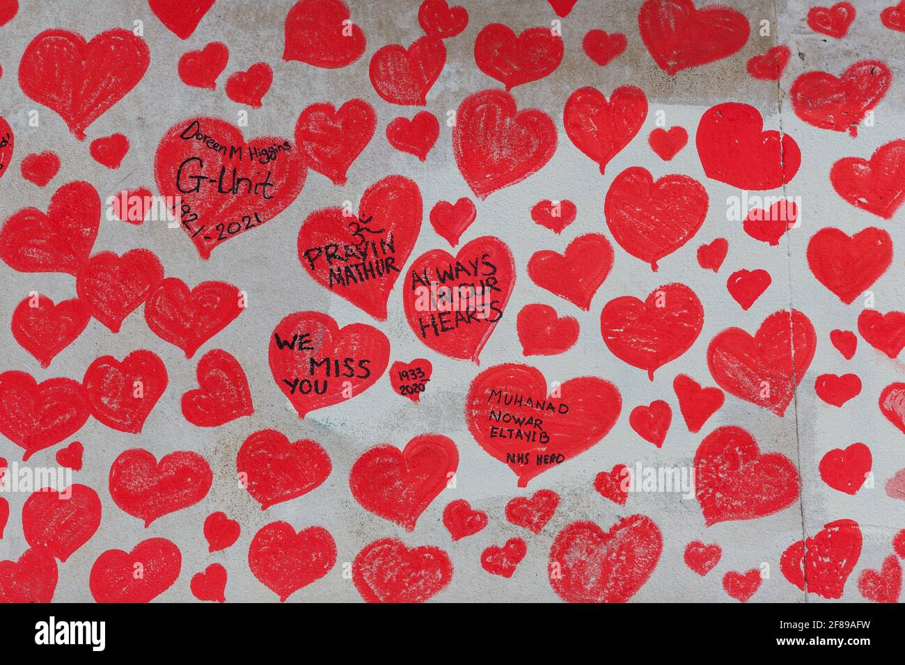 Red hearts painted on the National Covid Memorial Wall as a tribute to the British victims of the Coronavirus pandemic Stock Photo