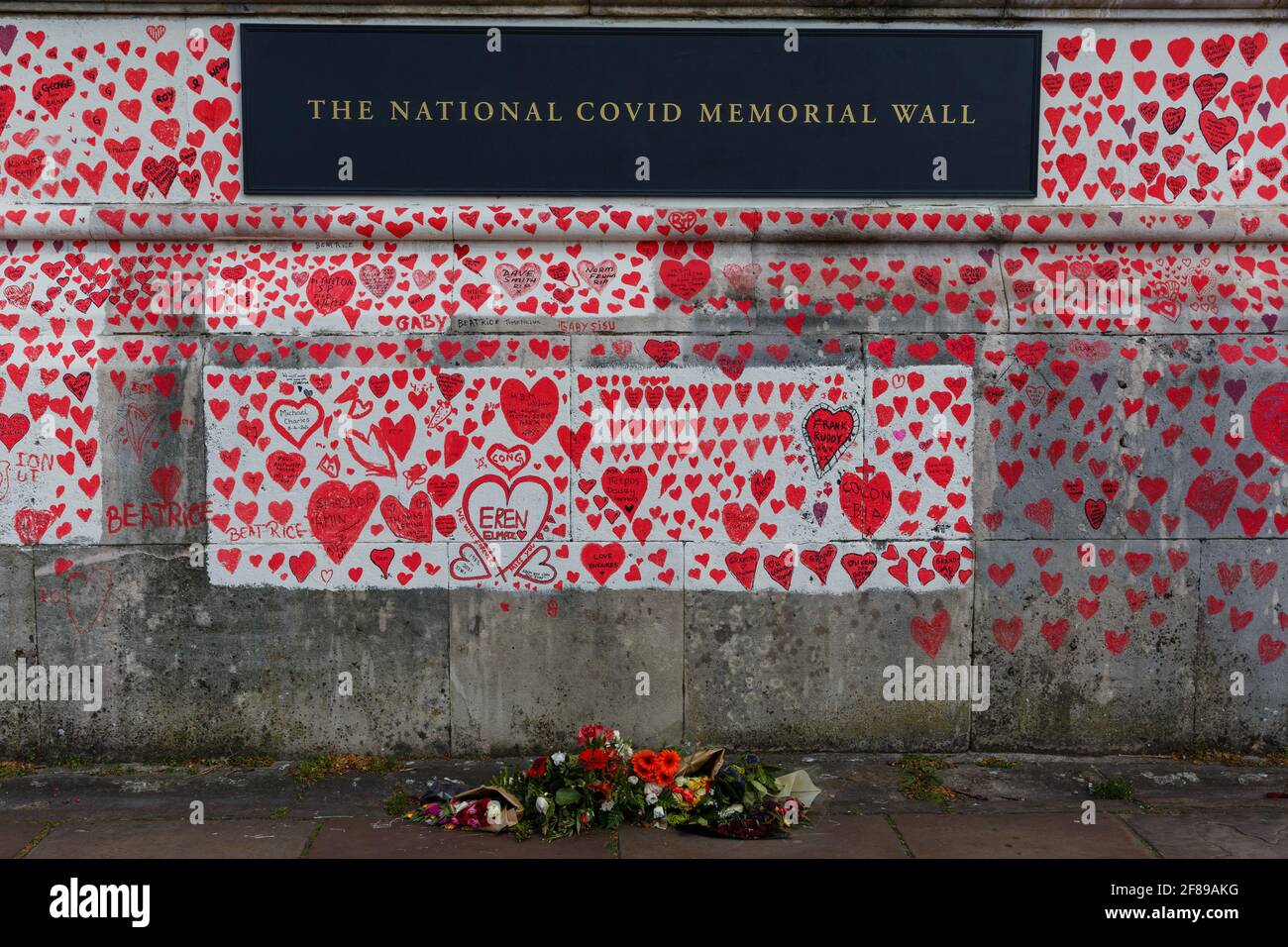Red hearts painted on the National Covid Memorial Wall as a tribute to the British victims of the Coronavirus pandemic Stock Photo