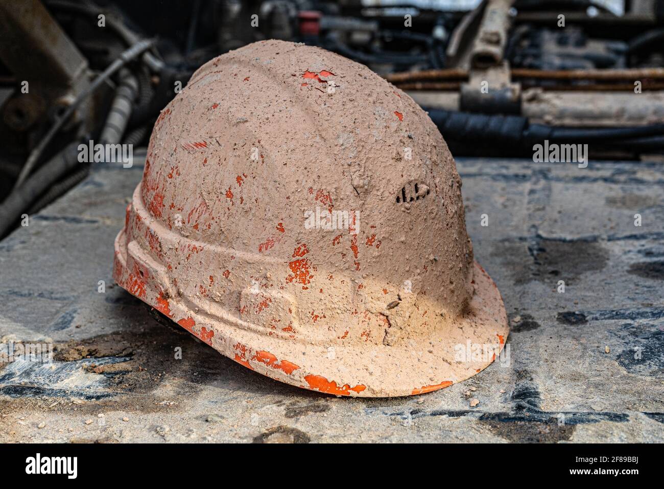 construction protective helmet covered with mud and drilling mud