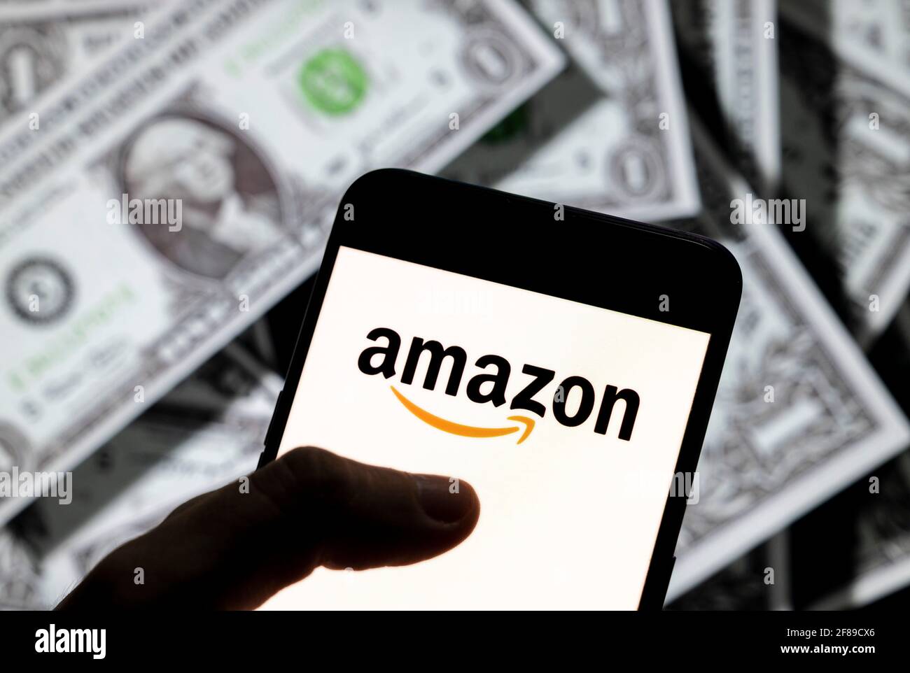 In this photo illustration, the American electronic commerce and cloud  computing company Amazon logo seen on an Android mobile device screen wit  the currency of the United States dollar icon, $ icon