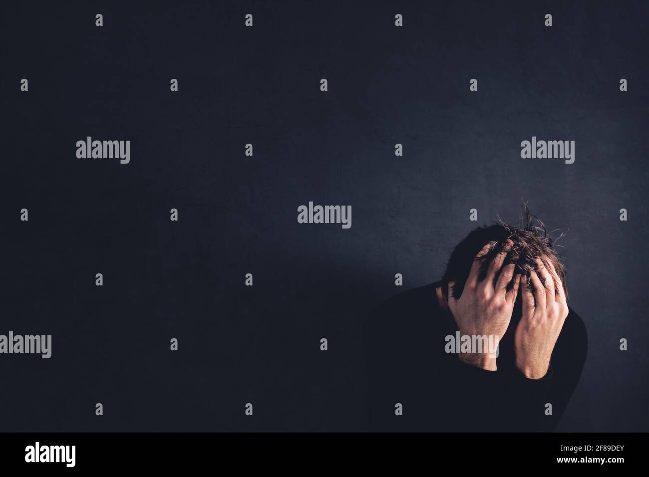 Bereavement concept, sadness and loneliness experienced after loss, adult caucasian male crying Stock Photo