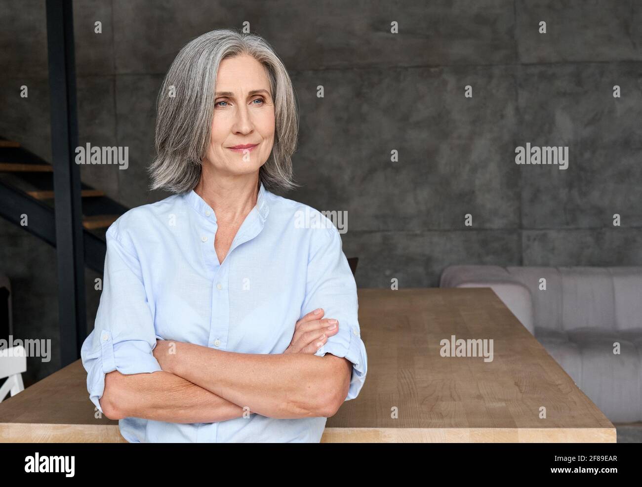 Professional portrait of business woman standing in home office. Stock Photo