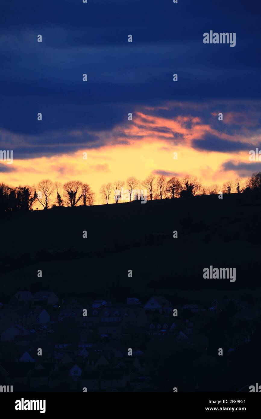 Stroud, UK, 12th April, 2021. UK Weather. Sunset colours over Randwick woods in Stroud, Gloucestershire. Credit: Gary Learmonth / Alamy Live News Stock Photo