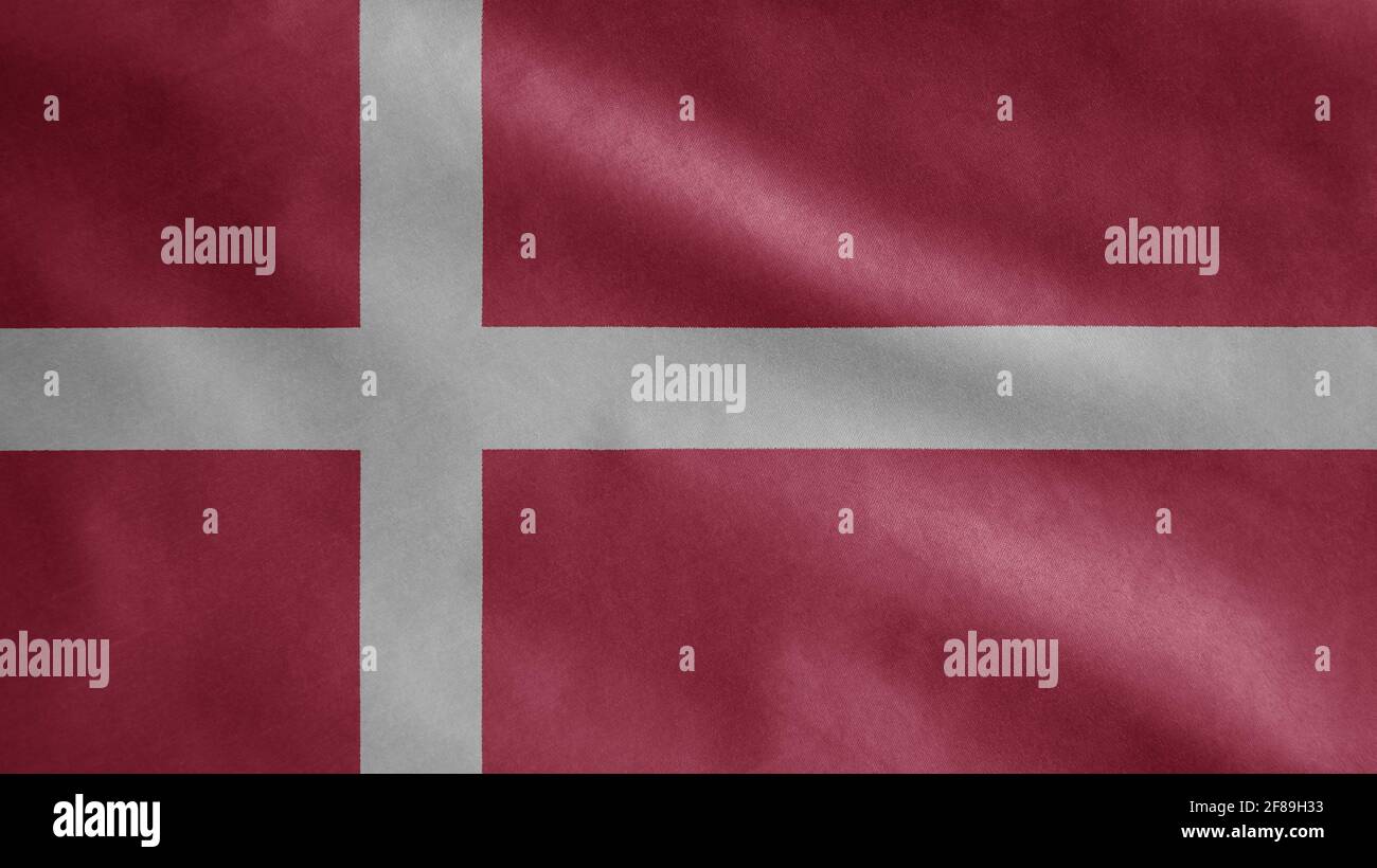 Danish flag waving in the wind. Close up of Denmark banner blowing, soft and smooth silk. Cloth fabric texture ensign background. Use it for national Stock Photo