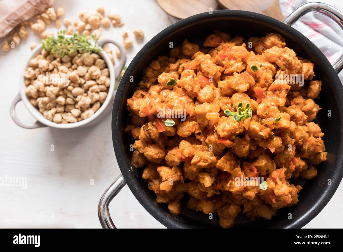 Closeup view of a black casserole full of healthy bolognese soya meat. Stock Photo