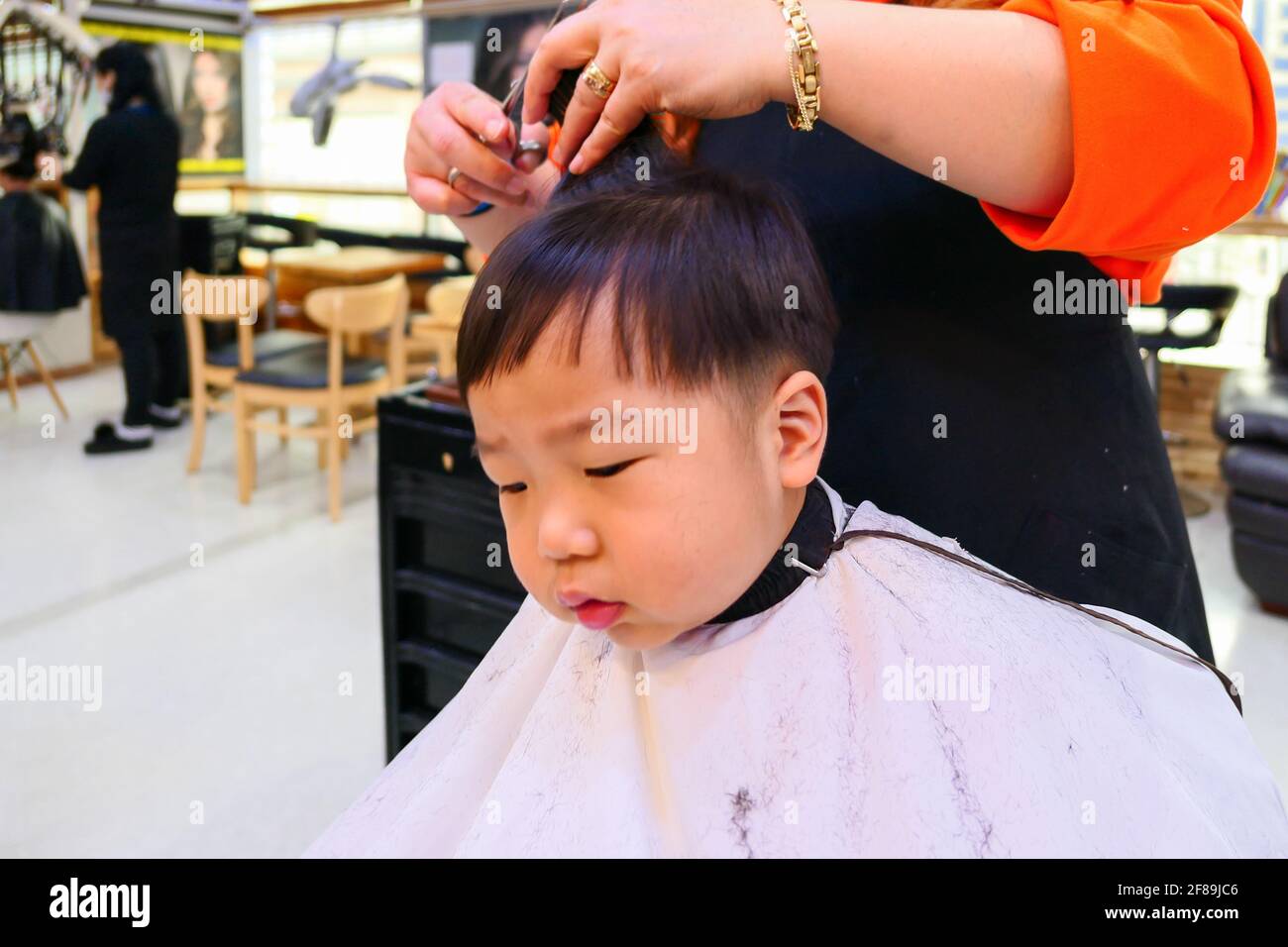 Asian cute baby boy getting hair cut (korean baby Stock Photo - Alamy