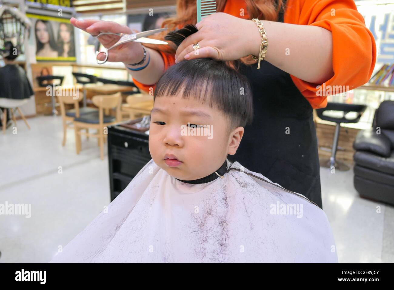 Asian cute baby boy getting hair cut (korean baby Stock Photo - Alamy