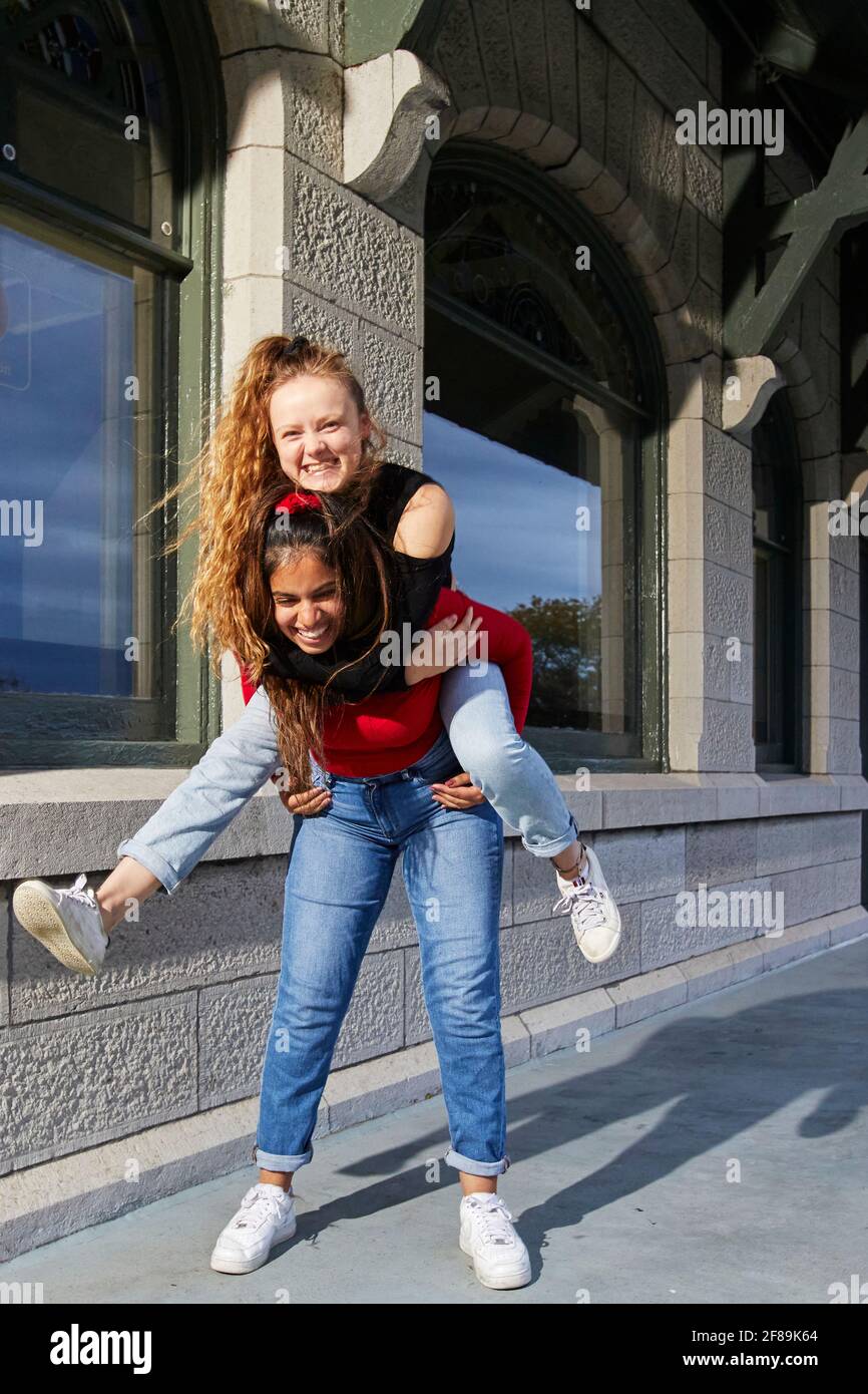 Two girls best friends since kindergarten, reuniting and having a fun evening Stock Photo