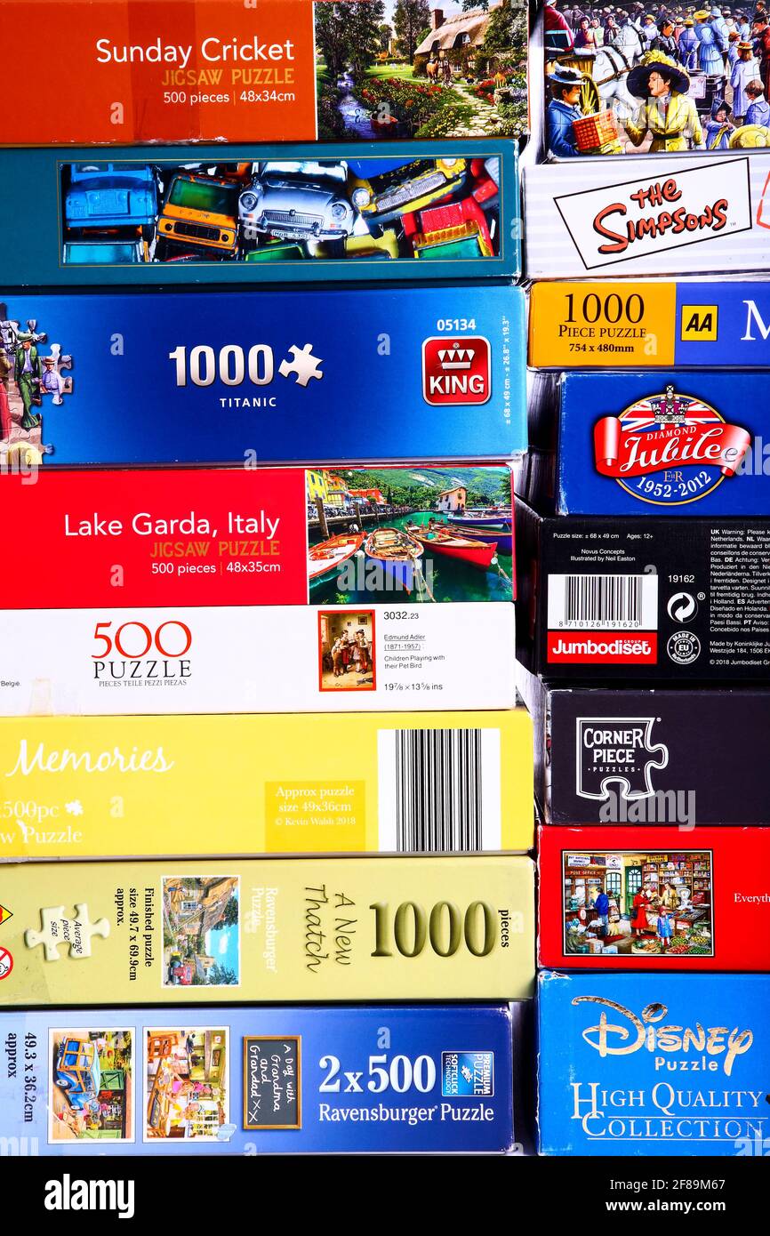 Stack of jigsaw puzzle boxes waiting to be solved Stock Photo Alamy