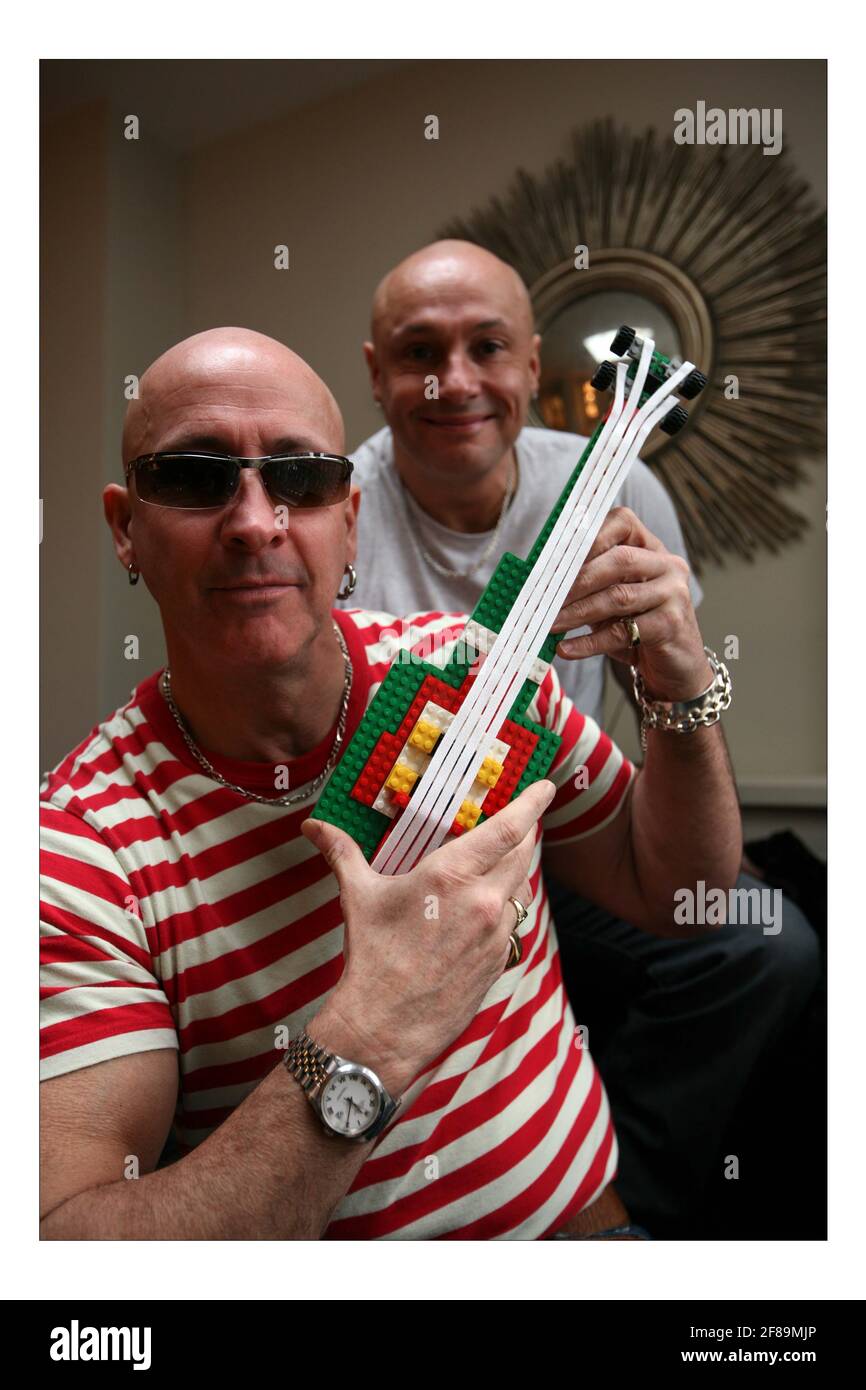 LEGO..... 'Right Said Fred' Fred (grey T shirt) and Richard (red stripe T shirt)  Fairbrass with their LEGO guitar at home in west London  pic David Sandison Stock Photo