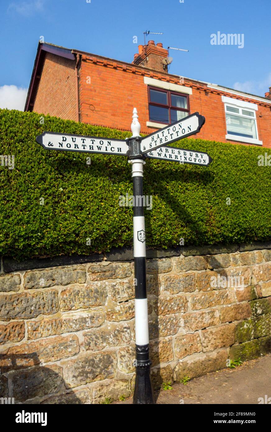 Finger post sign post in the Cheshire village of Preston on the Hill showing directions to Cheshire villages Stock Photo