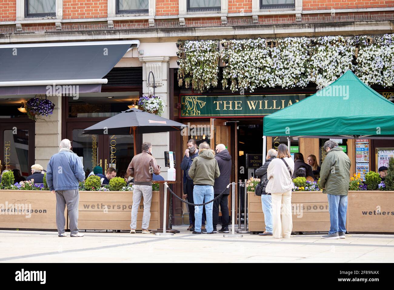 London, UK - 12 Apr 2021: Customers queue at the William Morris pub in ...