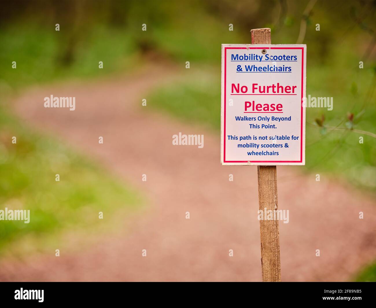 A sign marking a path inaccessible to mobility scooters wheelchairs at the bluebell walk at Bates Green Farm in Arlington, East Sussex, UK Stock Photo