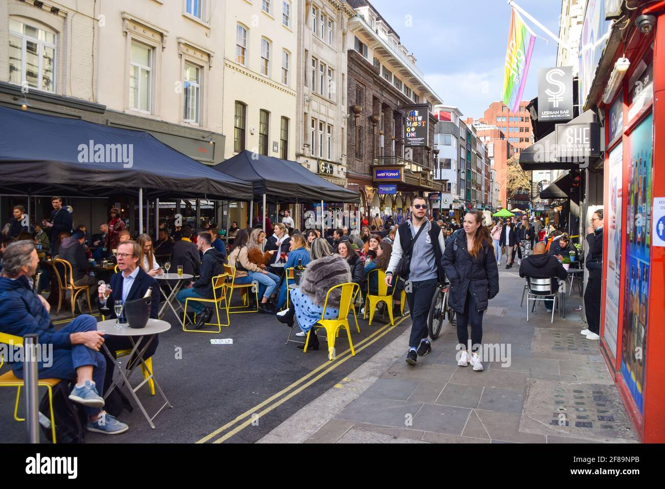London, United Kingdom. 12th April 2021. Busy bars and restaurants in Old Compton Street, Soho. Shops, restaurants, bars and other businesses reopened today after almost four months as further lockdown rules are relaxed in England. Stock Photo