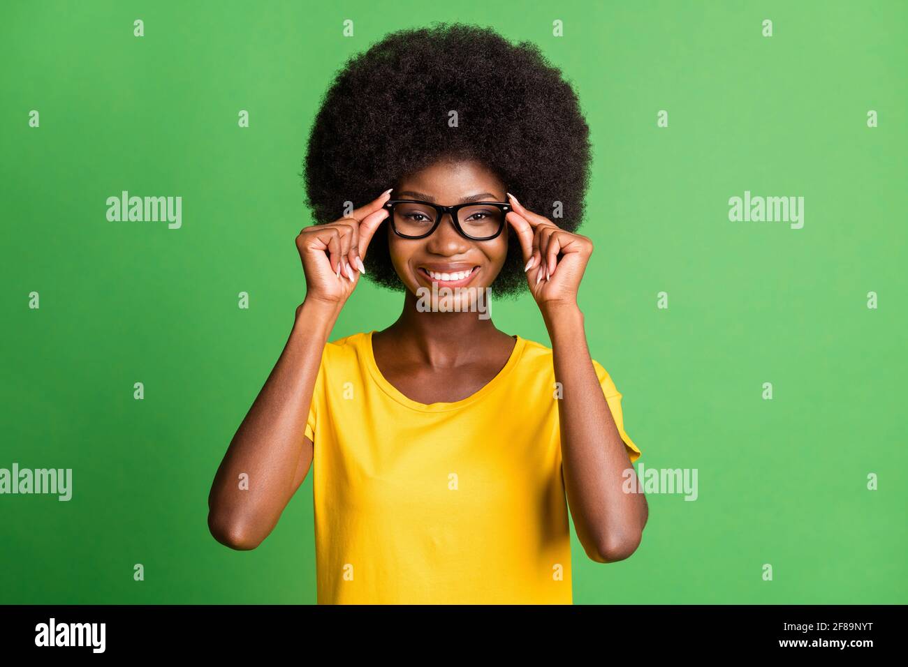 Photo of cheerful happy nice dark skin woman hold wear glasses good mood  isolated on green color background Stock Photo - Alamy