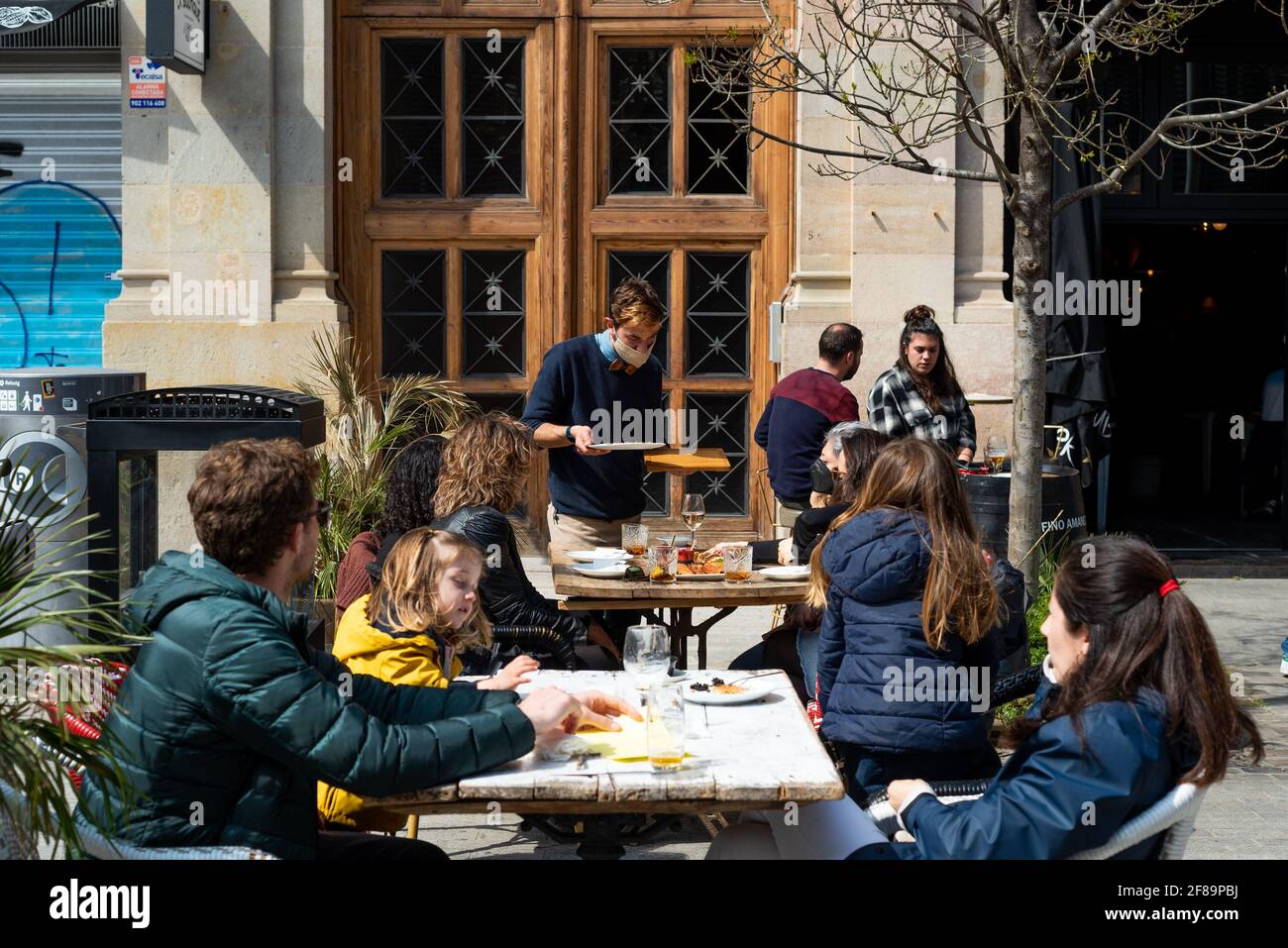 People sit in open air terrace of a restaurant in the Gothic quarter of Barcelona, Spain on March 27, 2021. Easing of covid-19 restrictions and lockdown means people can eat and drink out in public spaces. Spanish government is trying to reopen the tourism and hospitality industries to push the economic recovery (Photo by Davide Bonaldo/Sipa USA) Stock Photo