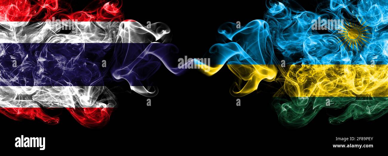 Thailand, Thai vs Rwanda smoky mystic flags placed side by side. Thick colored silky abstract smokes flags. Stock Photo