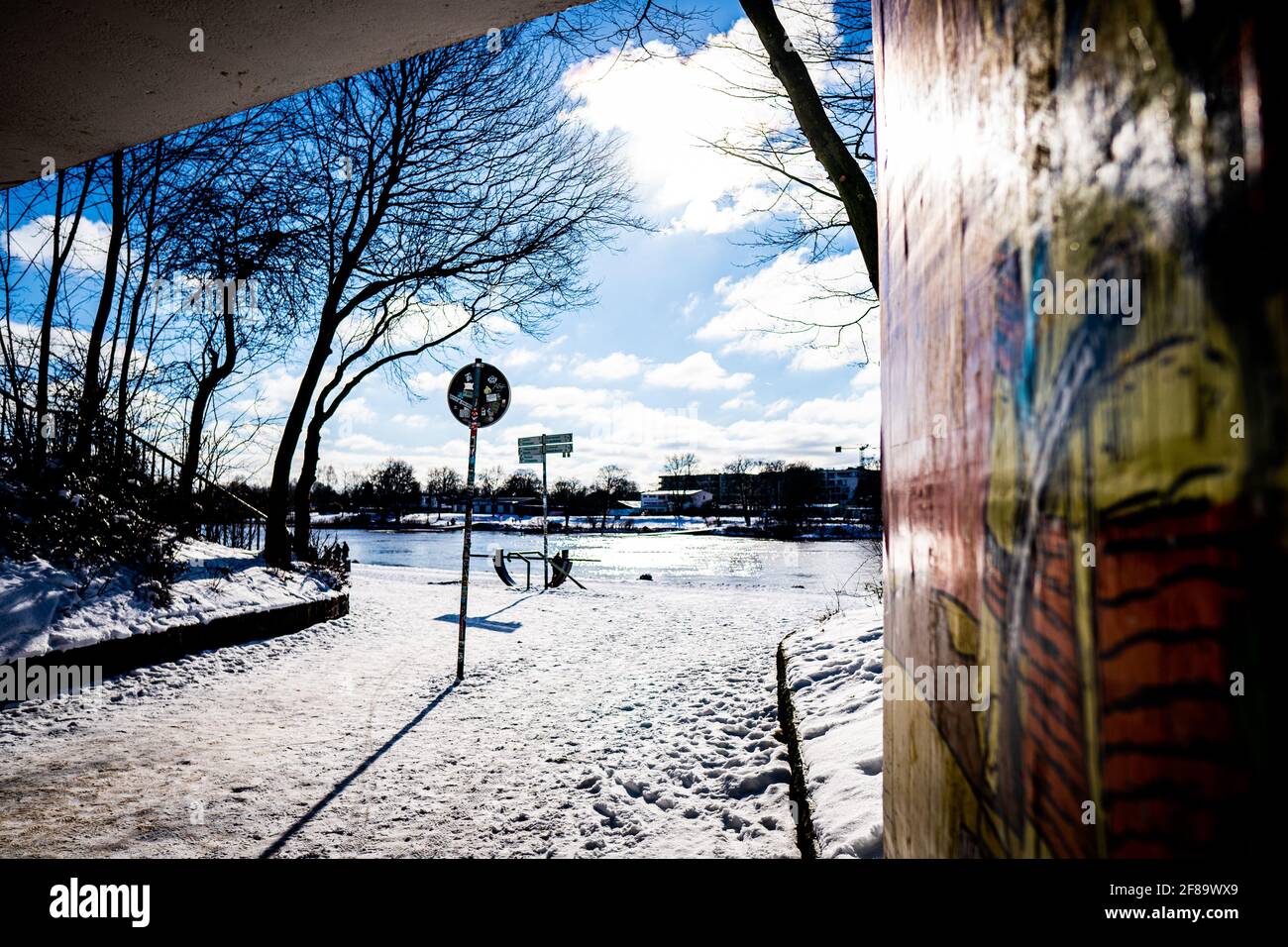 view from rabbit hole, an art tunnel in bremen, to snowy dike and weser in the sun Stock Photo