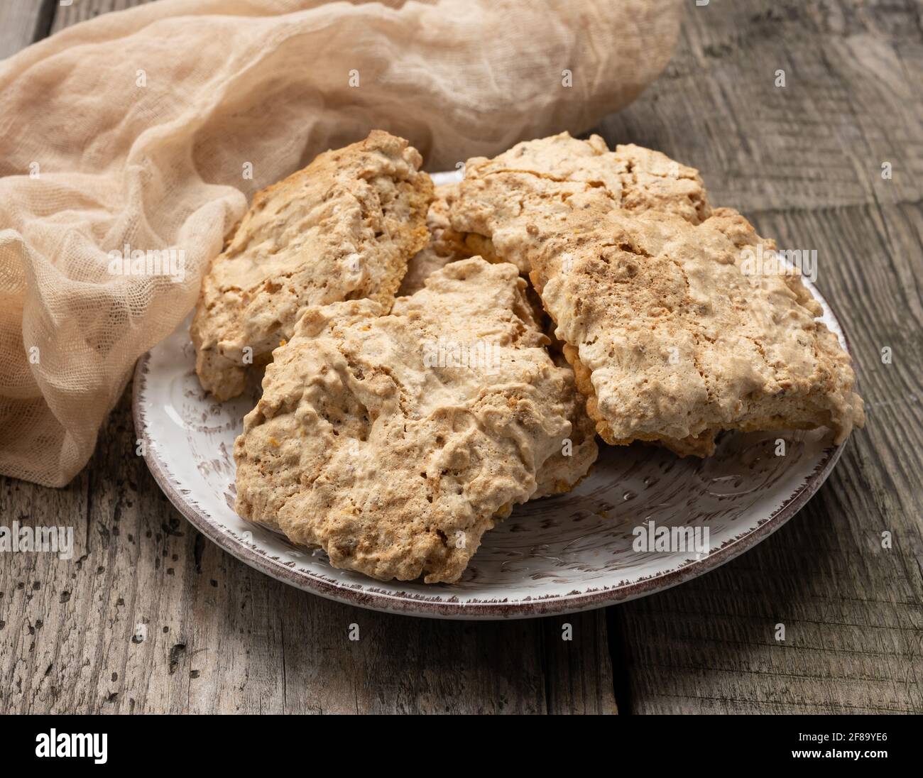 square baked cookie pieces lie in a round plate on the table, polish cookies, close up Stock Photo