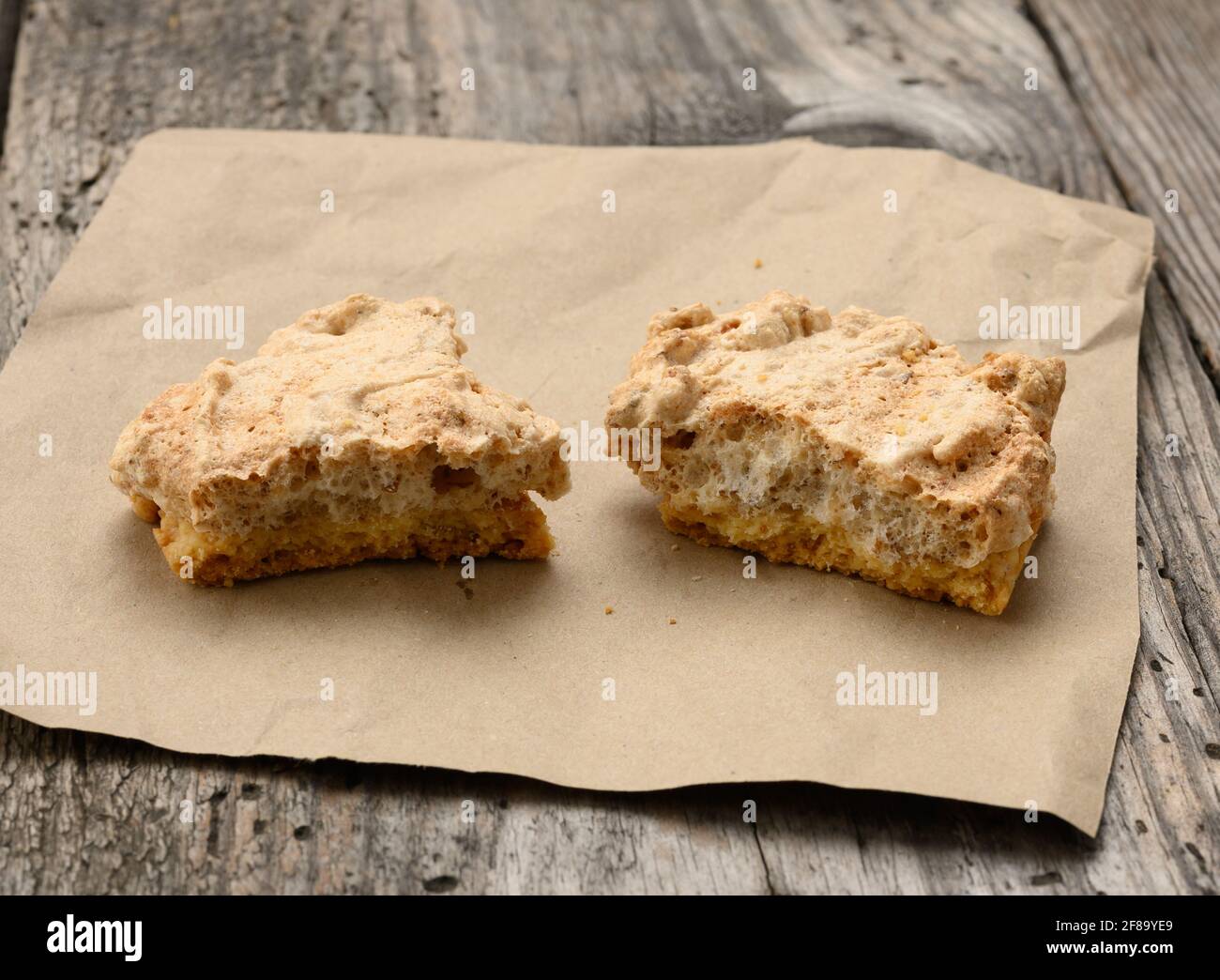square baked cookie pieces lie on a piece of paper, wooden gray table, polish cookies, top view Stock Photo