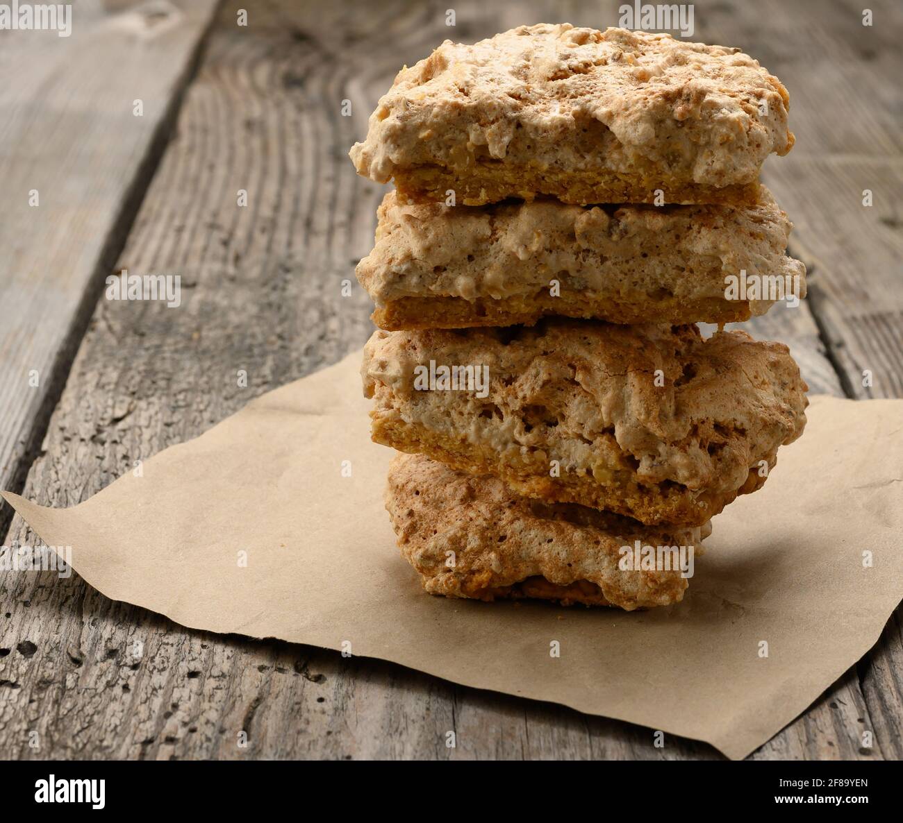 square baked cookie pieces lie on a piece of paper, wooden gray table, polish cookies, close up Stock Photo