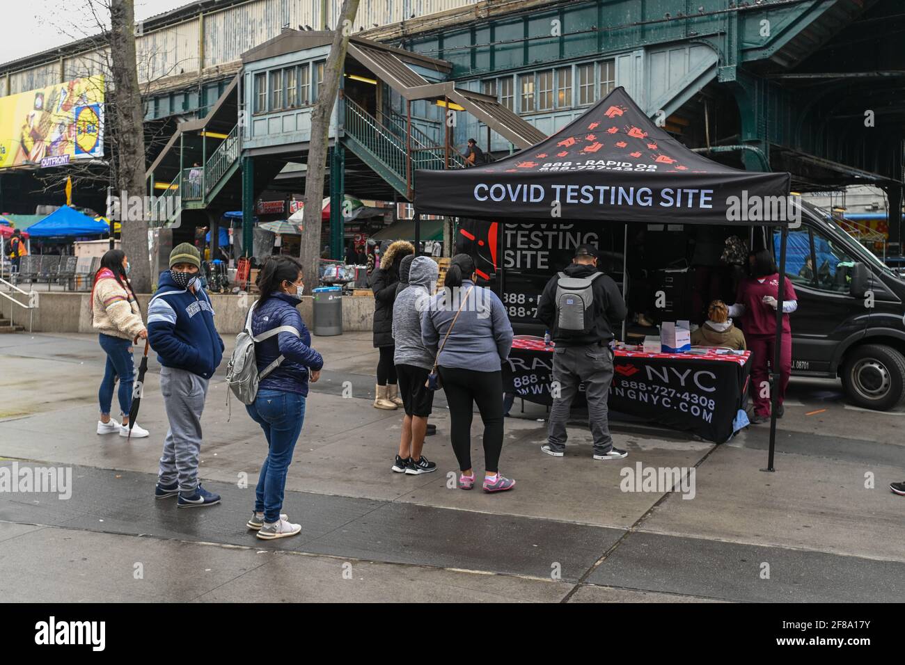 People wait in line at a mobile covid testing site in the Corona neighborhood of Queens in New York. 12 Apr 2021 Stock Photo