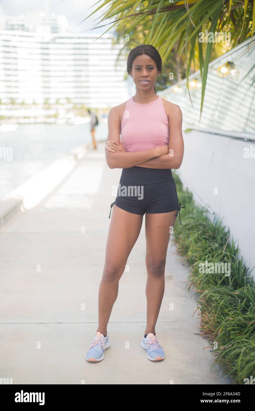 Portrait of a Young African American Woman in Standing and taking break from Jogging Stock Photo