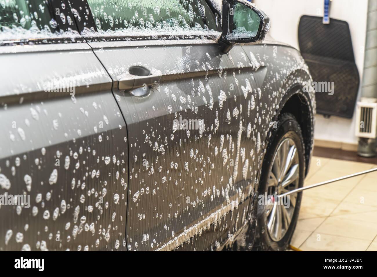 Emulsion of car shampoo with bubbles for primary washing of dirt or first phase on car wash. Stock Photo