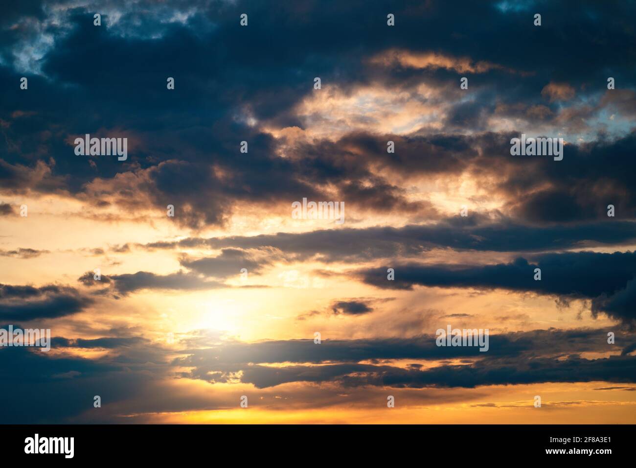 Dramatic sunset cloudy sky with blue clouds as abstract beautiful cloudscape background. Stock Photo