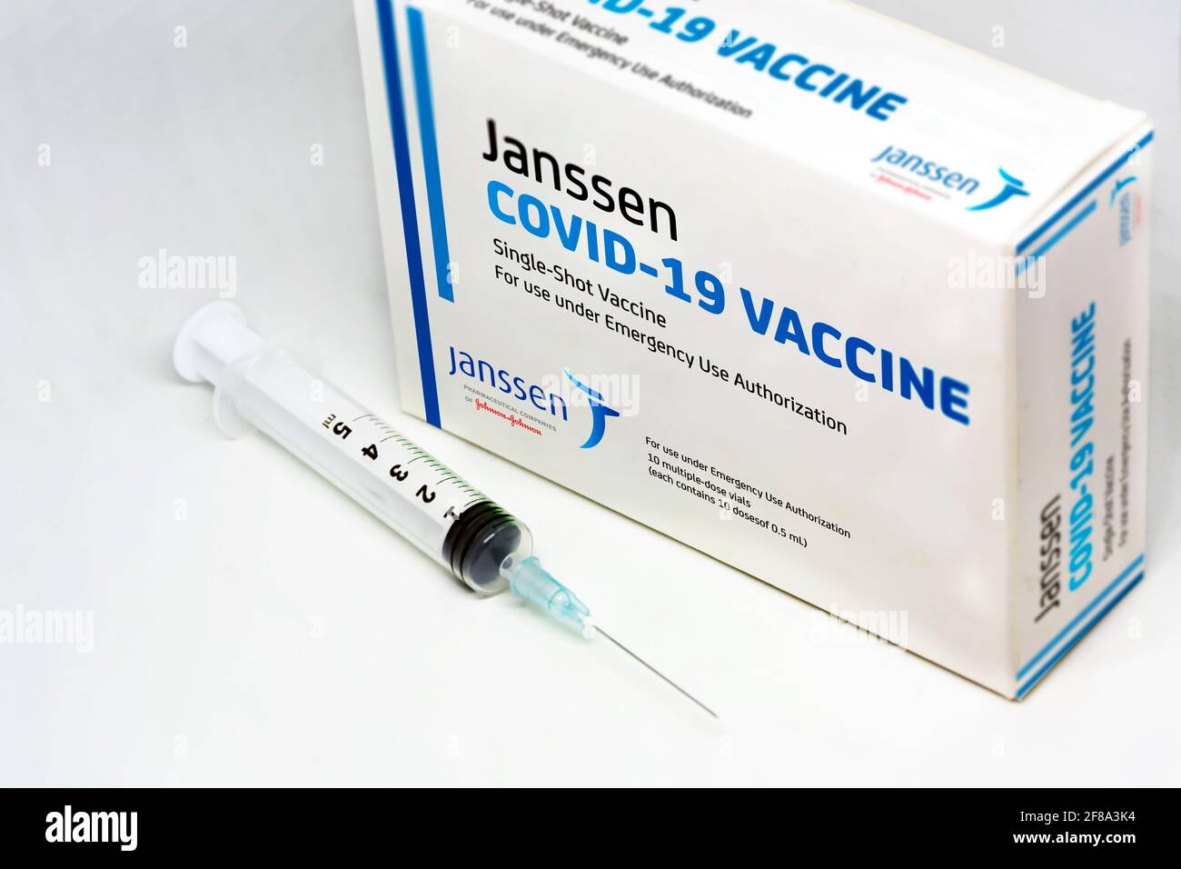 New York, USA, April 12th 2021: A syringe next to the Janssen Covid-19 vaccine box. Janssen is a subsiadiary company of Johnson and Johnson and devolo Stock Photo