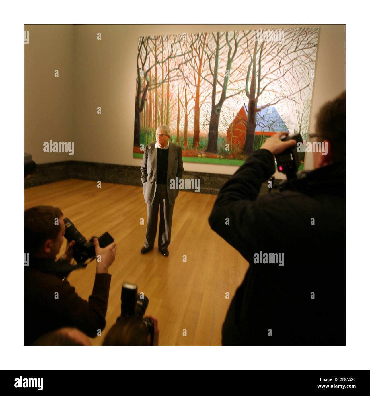 British artist David Hockney (L) poses for photographs next to a segment of his painting 'Bigger Tree's near Warter', at the Tate Britain in London. David Hockney has donated the artwork to the Tate Britainphotograph by David Sandison The Independent 7/4/2008 Stock Photo