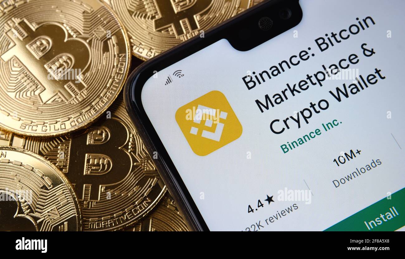Binance app seen on the smartphone screen placed on top bitcoin coins pile.  Concept. Stafford, United Kingdom, April 12, 2021 Stock Photo - Alamy